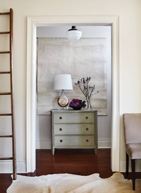 Gorgeous foyer with schoolhouse pendant, tapestry, gray washed chest and gray walls.