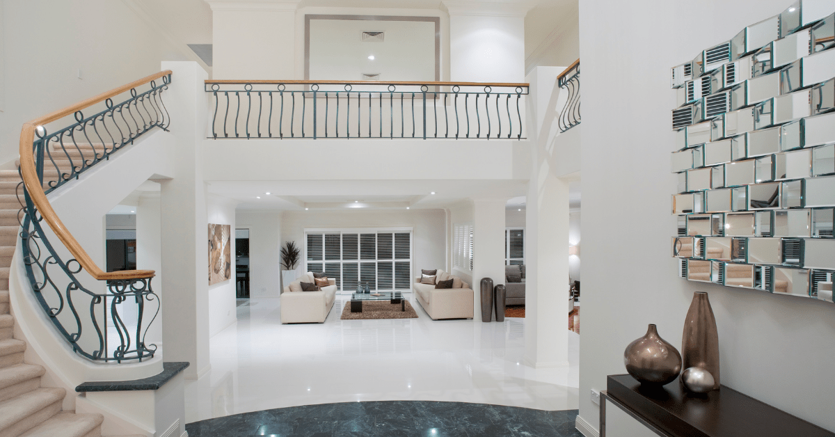 A luxurious hallway with a stylish focal wall decor and table for storage.