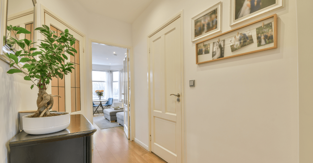 A hallway wall with pictures hung.