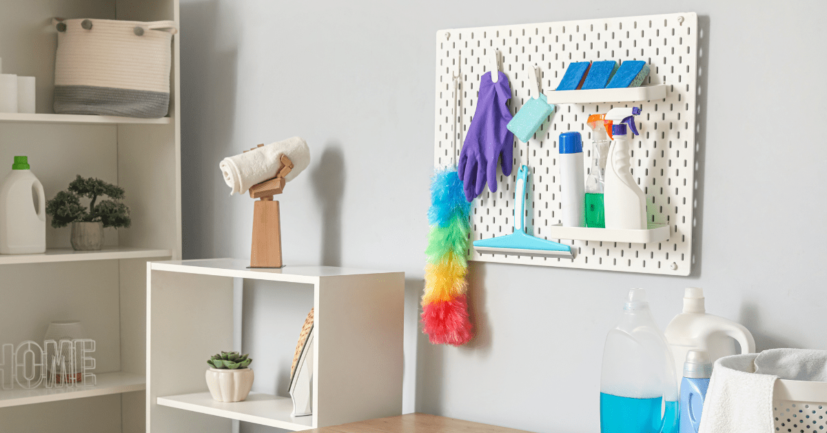 Cleaning supplies hanging from a pedboard.