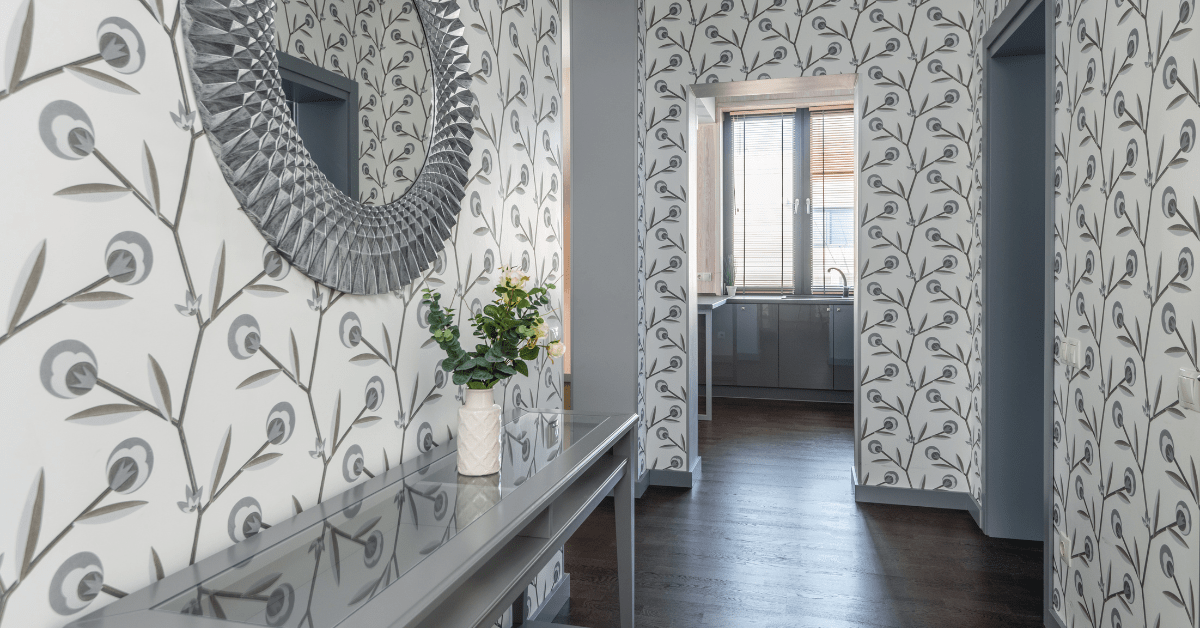 A hallway with grey wallpaper and stylish decor.