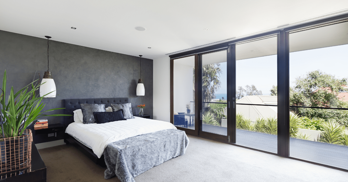 A luxurious master bedroom with black and white accents.