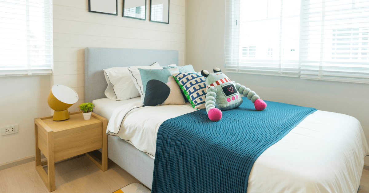 A sleek boys bedroom that's small.