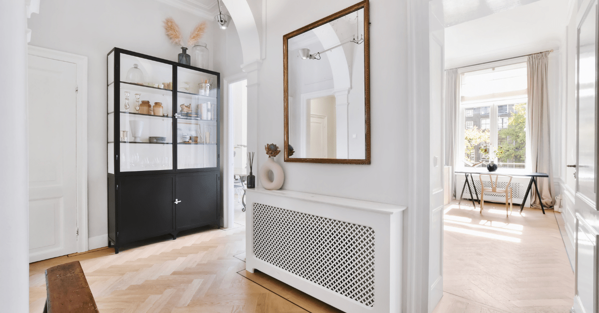 A unique hallway with mirror and other wall decor.