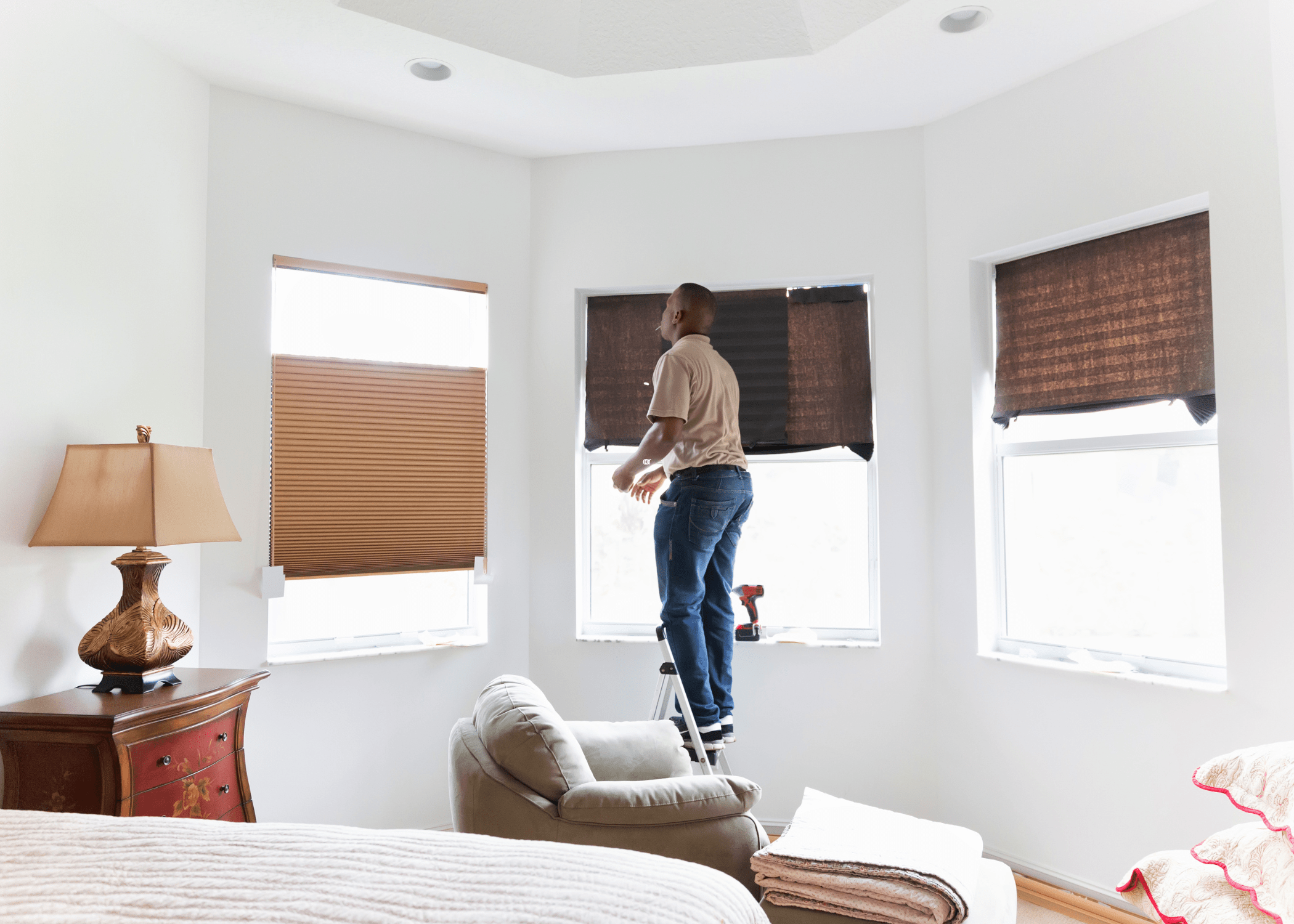 man handing blinds in bedroom