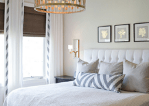 Clean, neutral bedroom with a custom Schumacher bolster and beautiful Circa light fixture. Custom drapery and a custom headboard complete the look. A dream for rainy days and breakfast in bed.