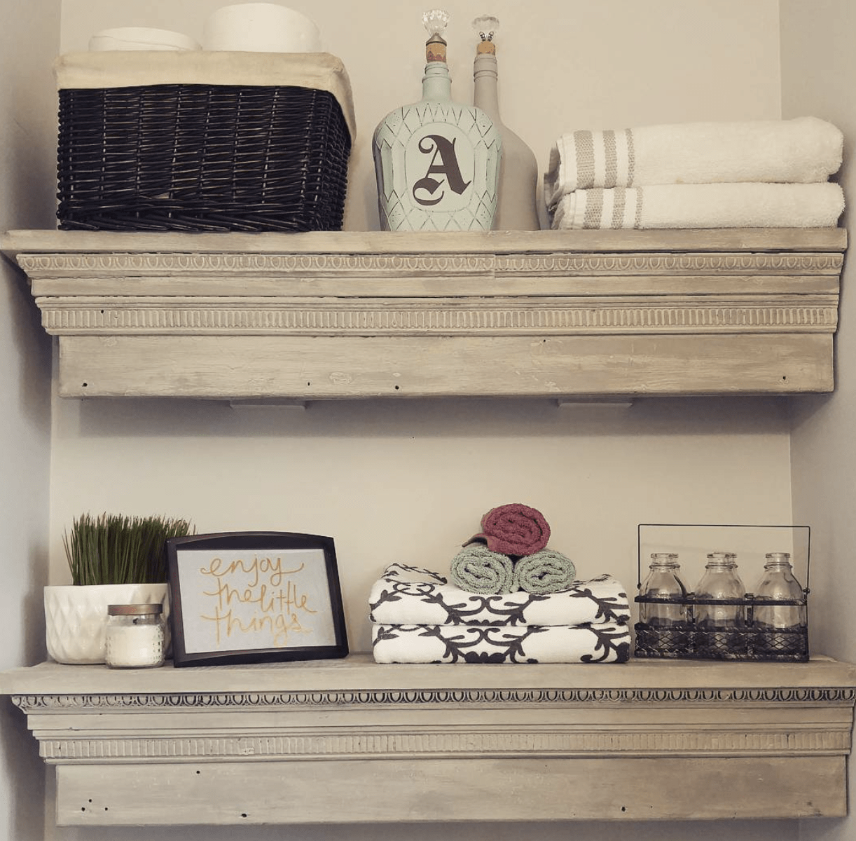 Two floating shelves in a half bathroom.